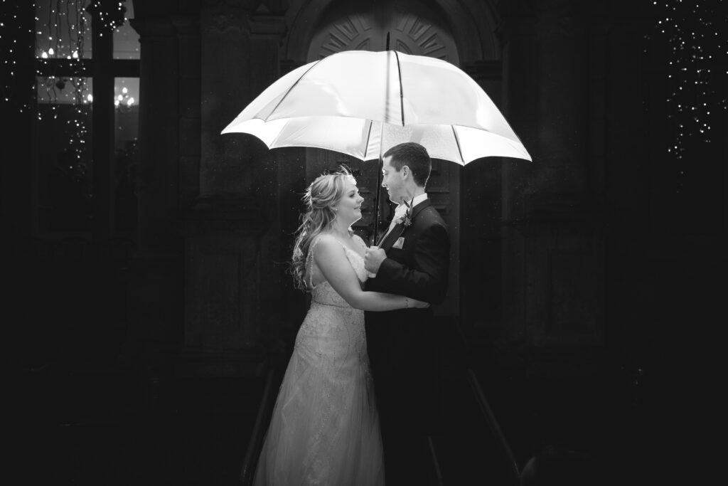 night time portrait of bride and groom in the rain