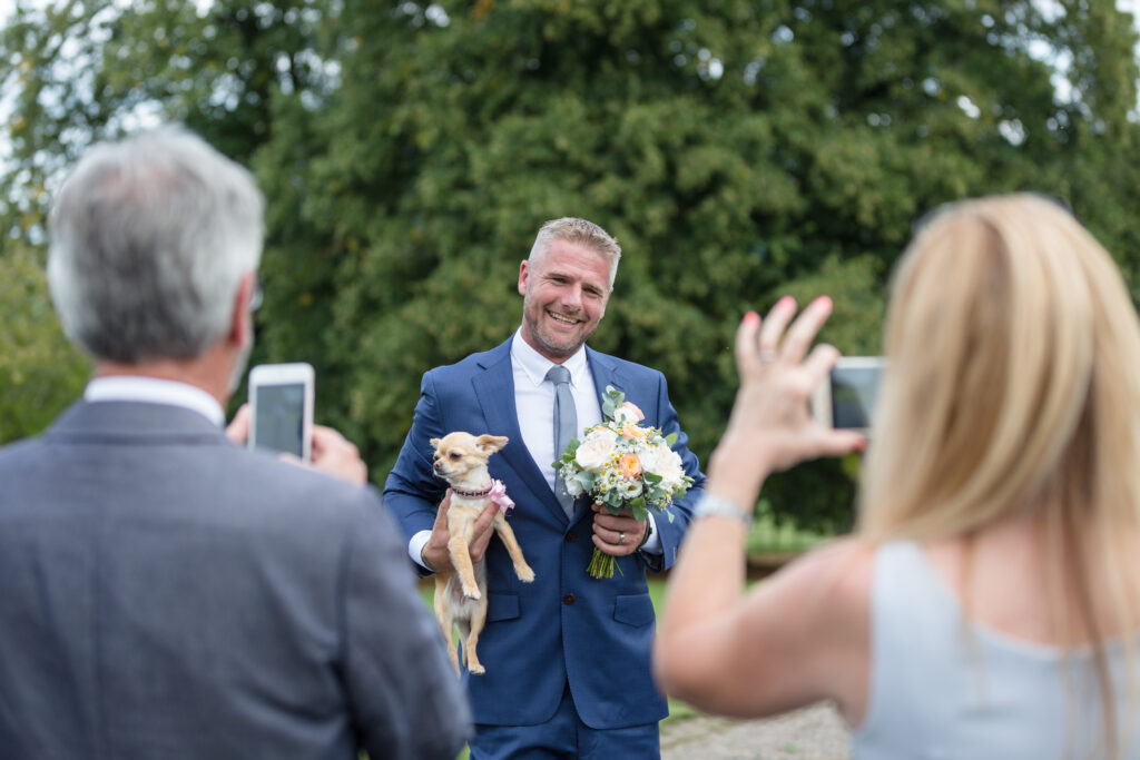 Groom with dog on wedding day by Kathryn Goddard Photography