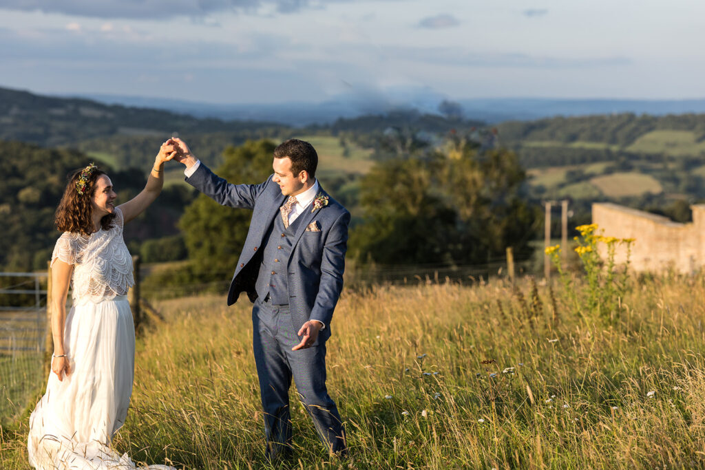 Bride and Groom on hillside during golden hour