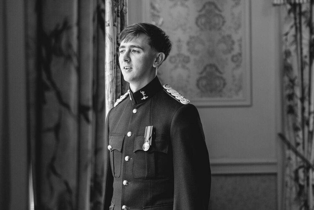 black and image portrait of groom wearing military dress at Clearwell Castle